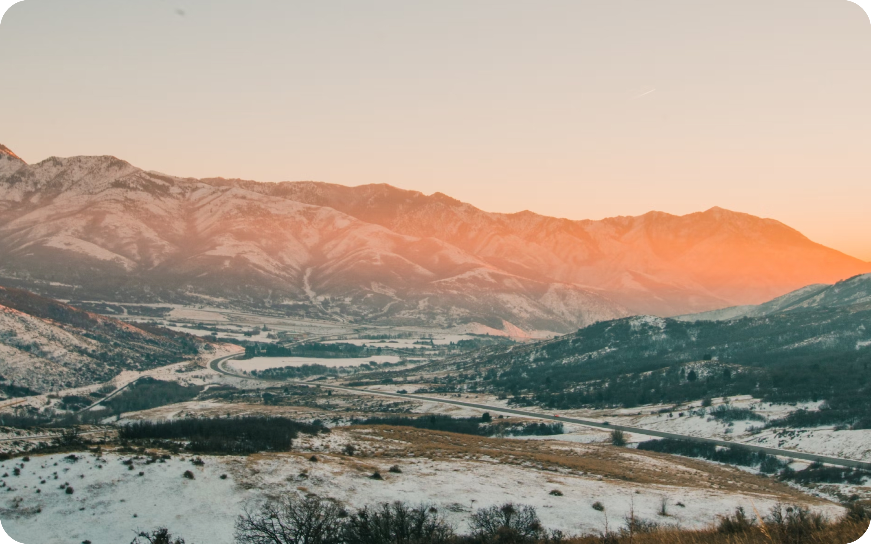 A scenic view of a sunset over mountains.