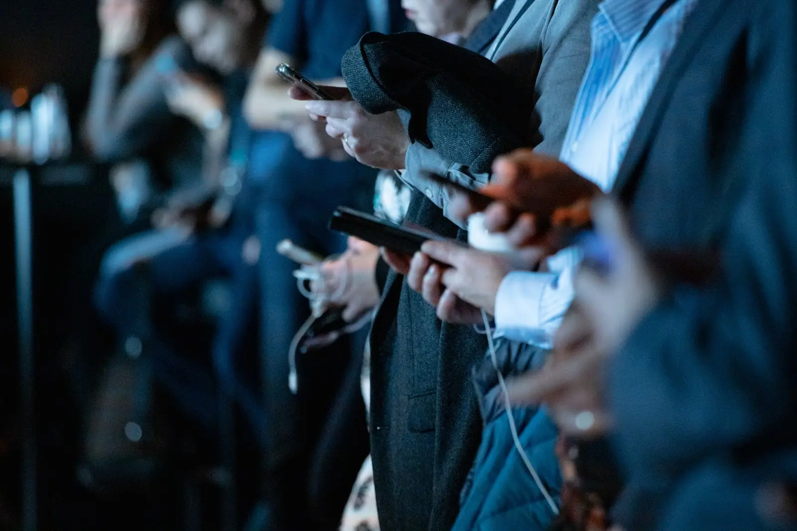 A line of people on cell phones
