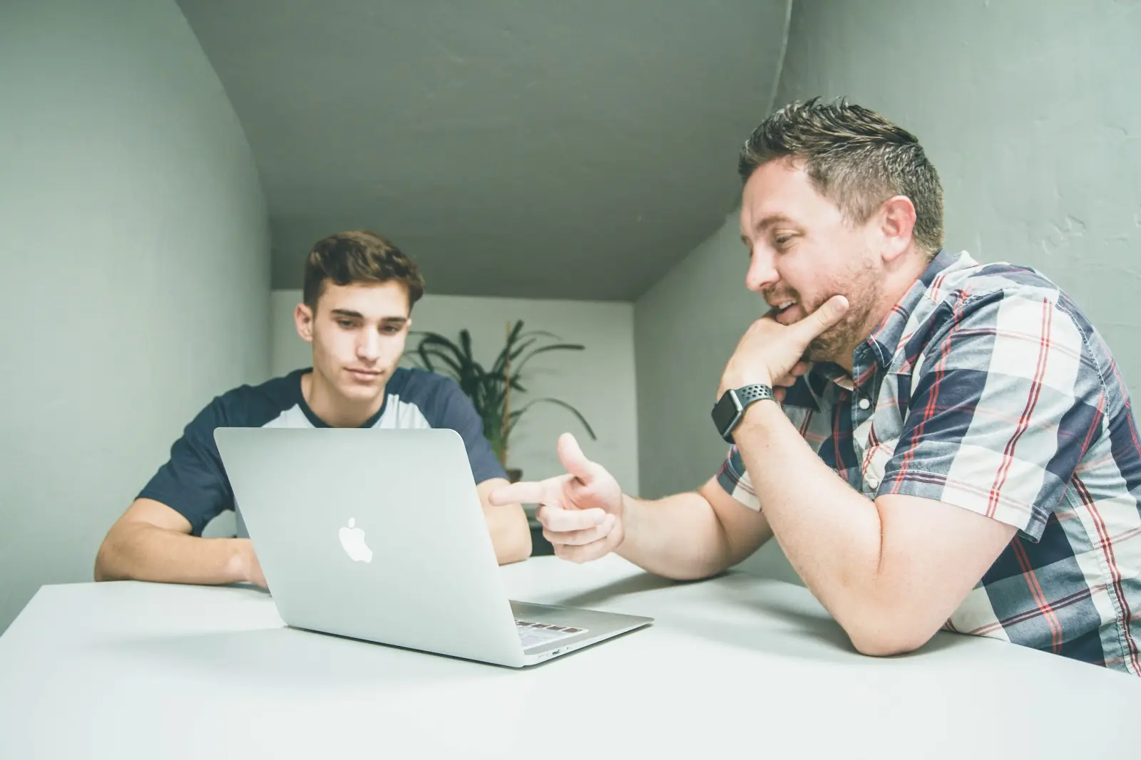 Two men looking at a computer