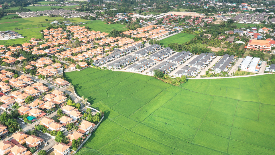An aerial view of many subdivisions built out in a city