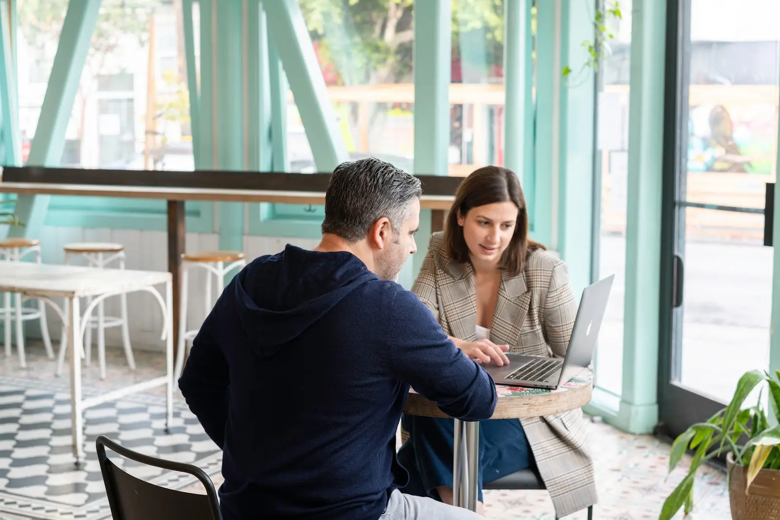 A man and woman sharing a laptop