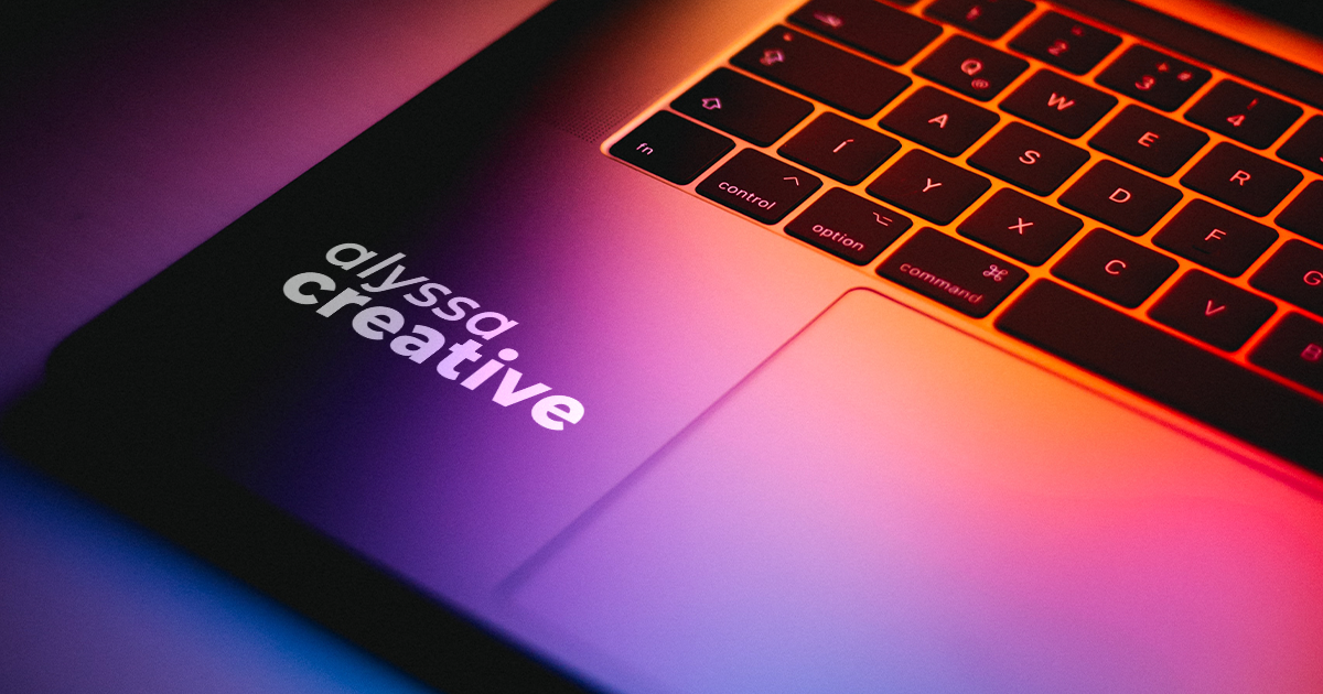 colorful lighting on a laptop with a sticker reading "Alyssa Creative"