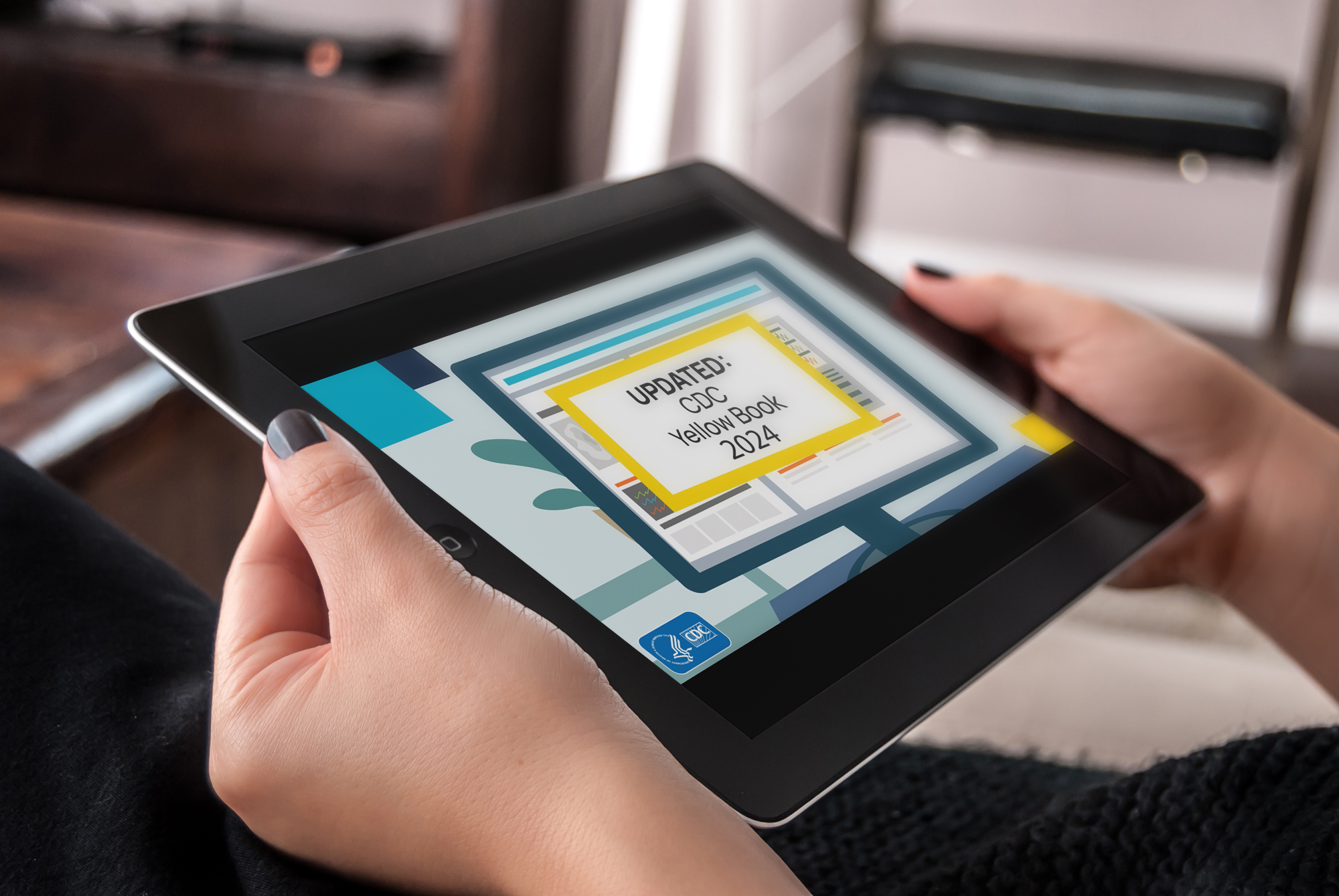 A person holding a tablet showing the “Updated: CDC Yellow Book 2024” web banner.