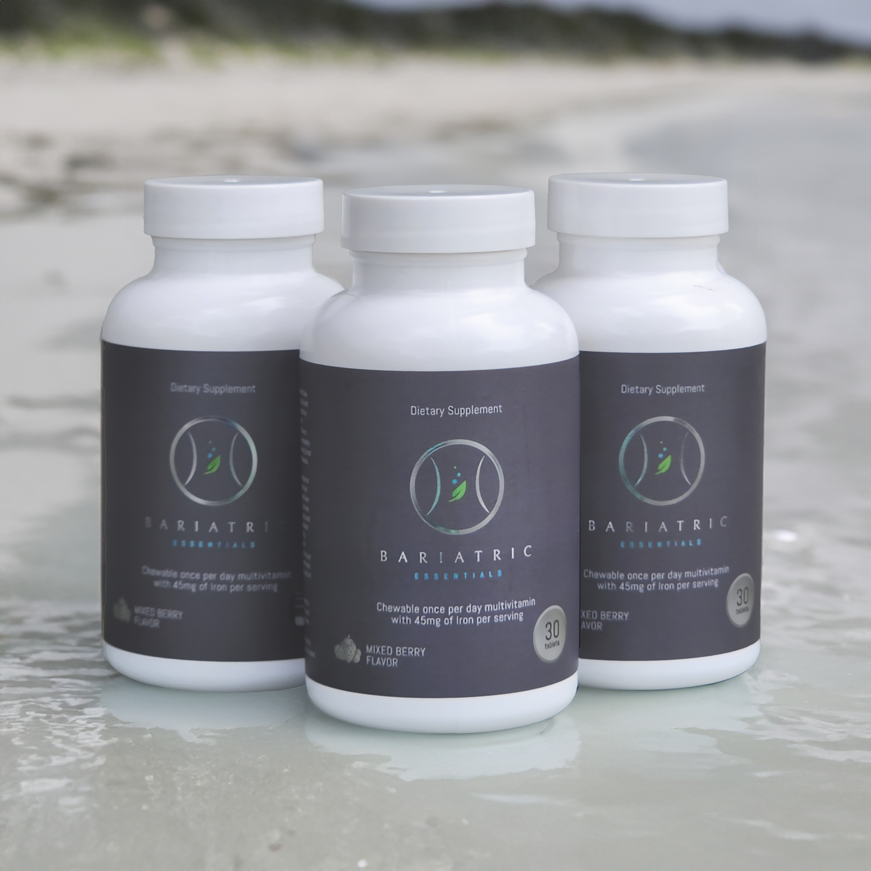 Three Bariatric Essentials product bottles lined up on a marble surface.