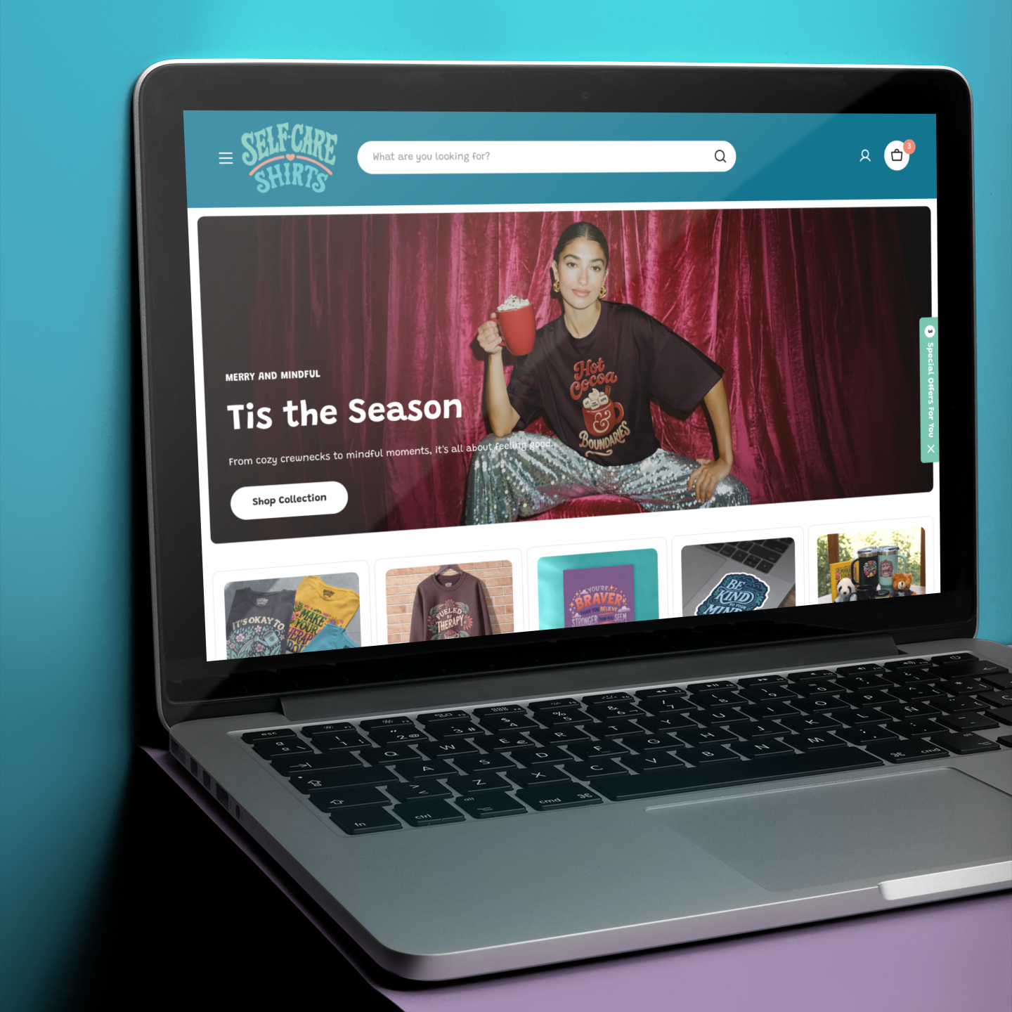 The Self-Care Shirts storefront homepage open on a laptop.