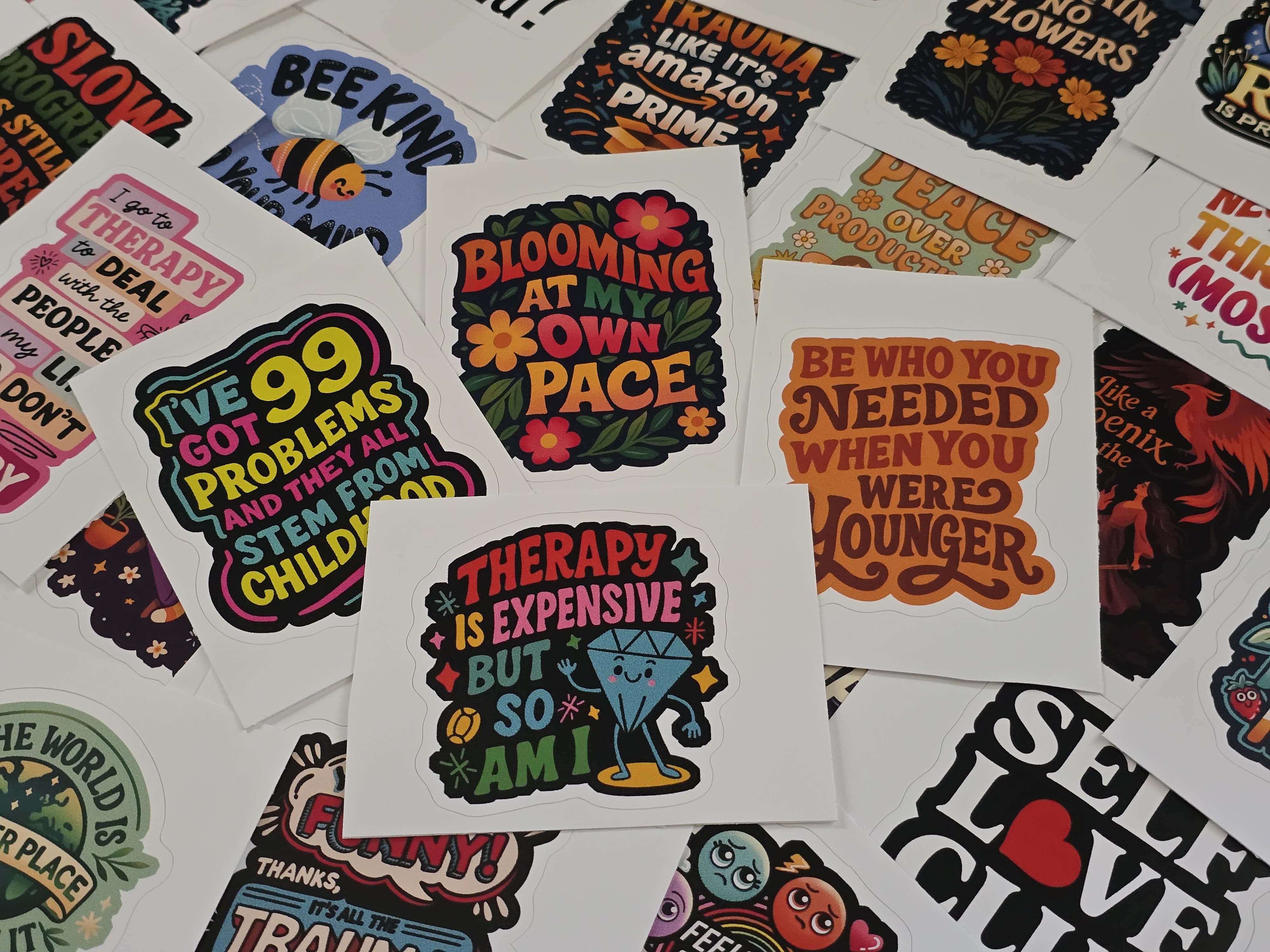 A scattered spread of Self-Care Shirts stickers, each carrying a different hand-drawn mental health message.