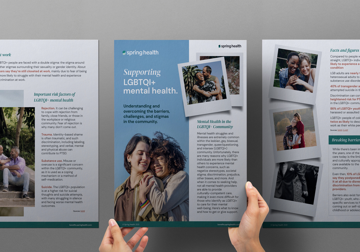 Hands holding an open Spring Health trifold on supporting LGBTQ+ mental health.