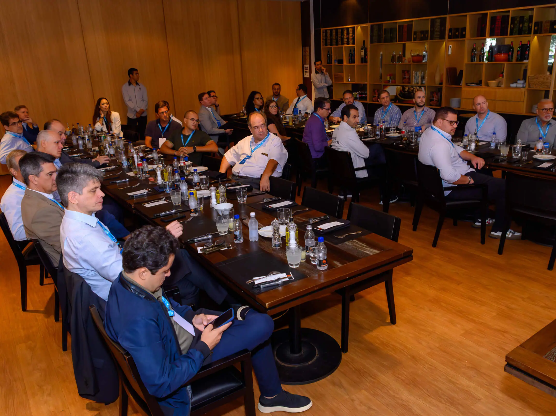 A private dinning room at an upscale restaurant full of executives and C-suit leaders of various companies for an exclusive event with Monks.