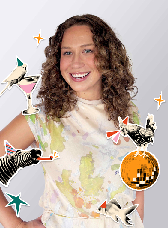 A woman with curly brown hair and her hand on her hip