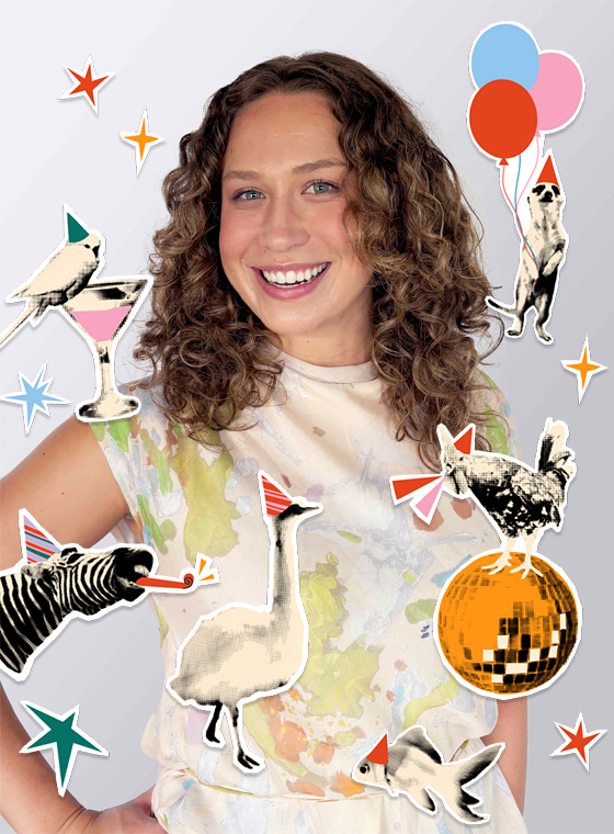 A woman with curly brown hair and her hand on her hip