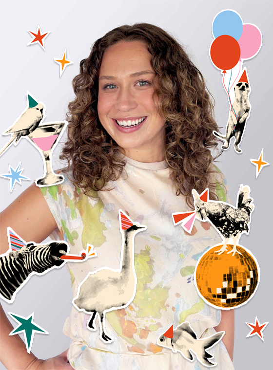 A woman with curly brown hair and her hand on her hip