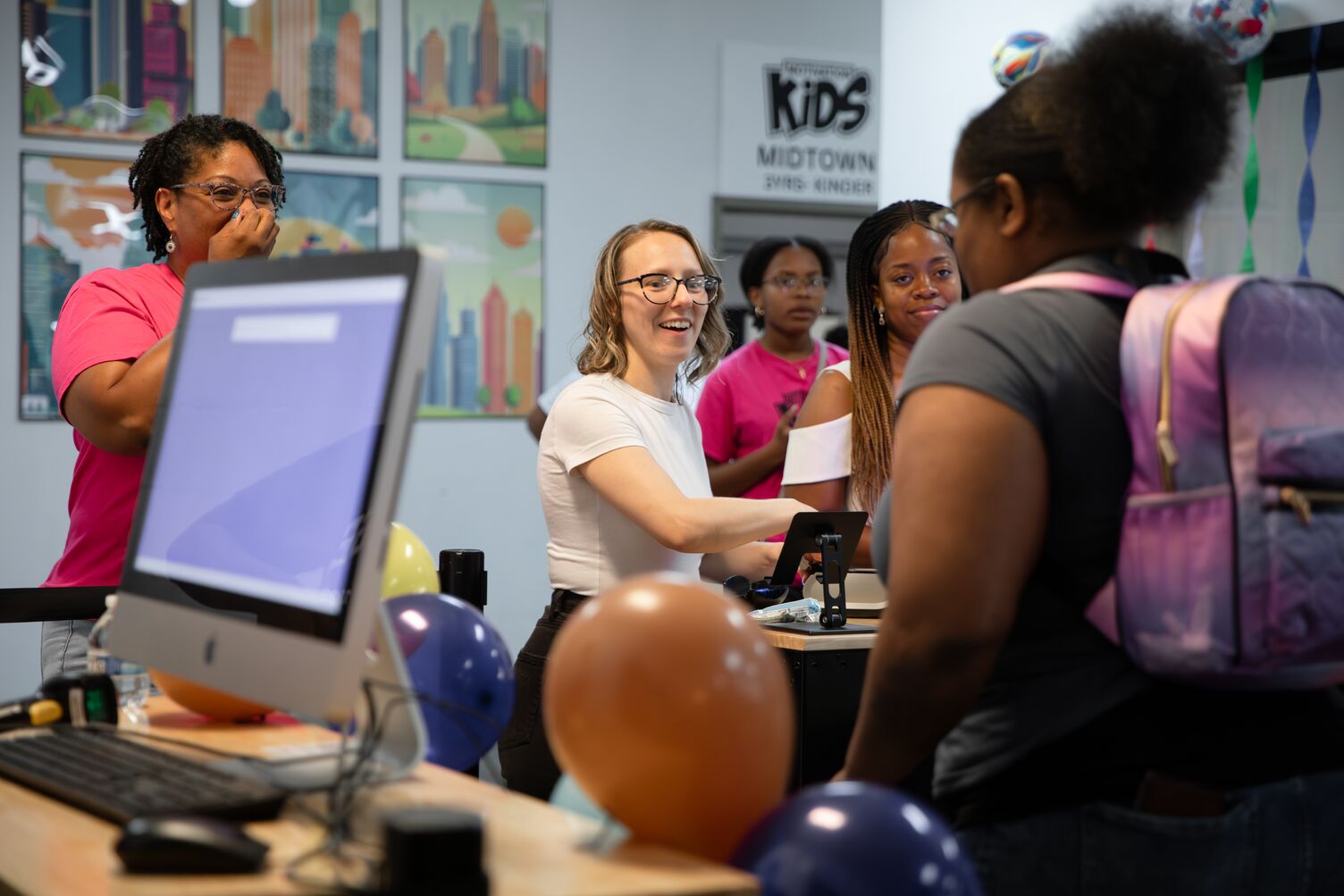 A woman checking in kids for kids church
