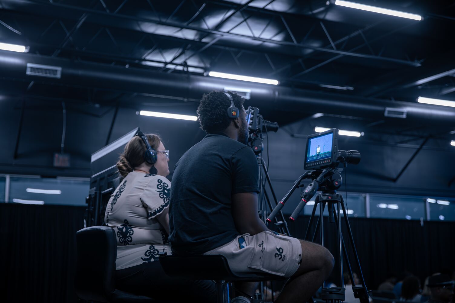 Two people recording on a camera