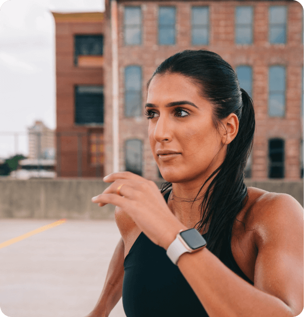 Woman in sports gear, wearing a smart watch