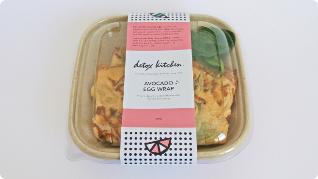 Packaging for an avocado egg wrap on a white background. The description on the label reads "free range egg wrap with avocado, tomato and hunmus"