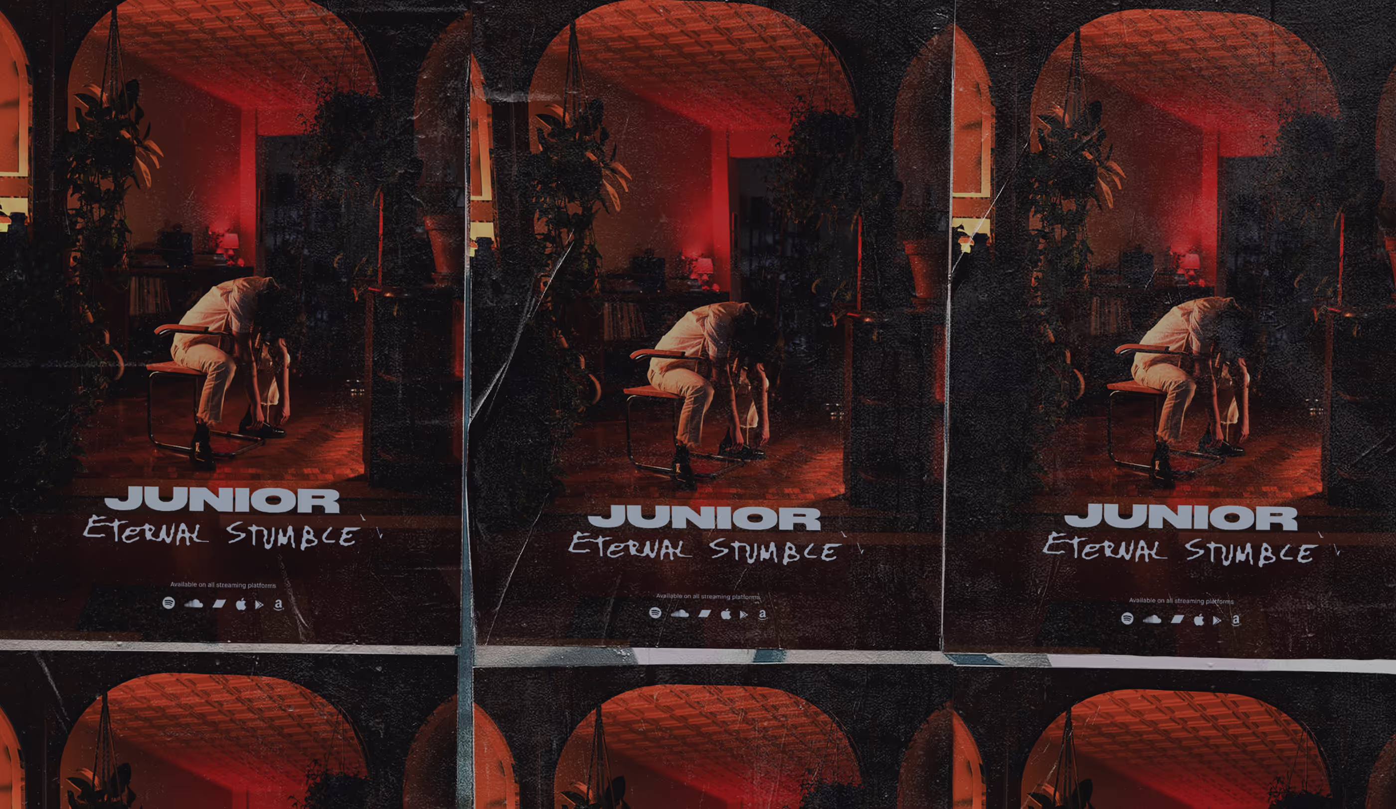 A lot of posters with the album artwork glued to a wall.