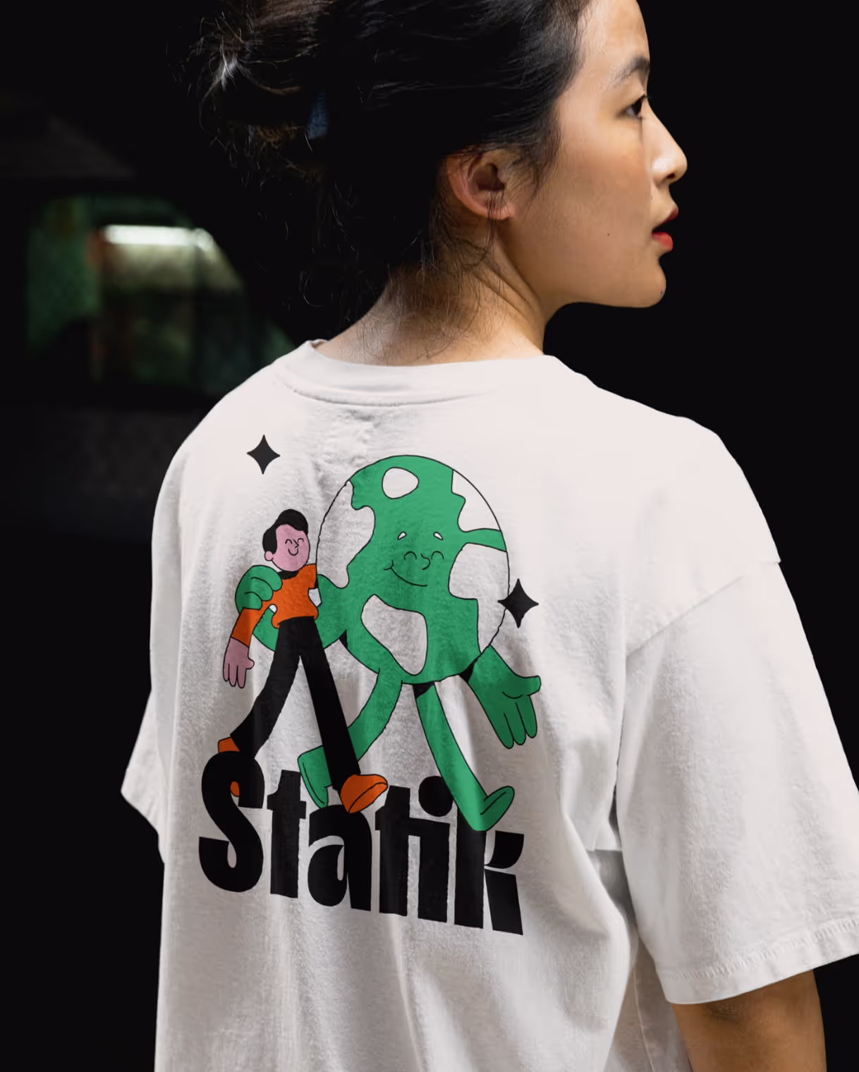 Woman with large back print on a t-shirt with an illustration of Statik.