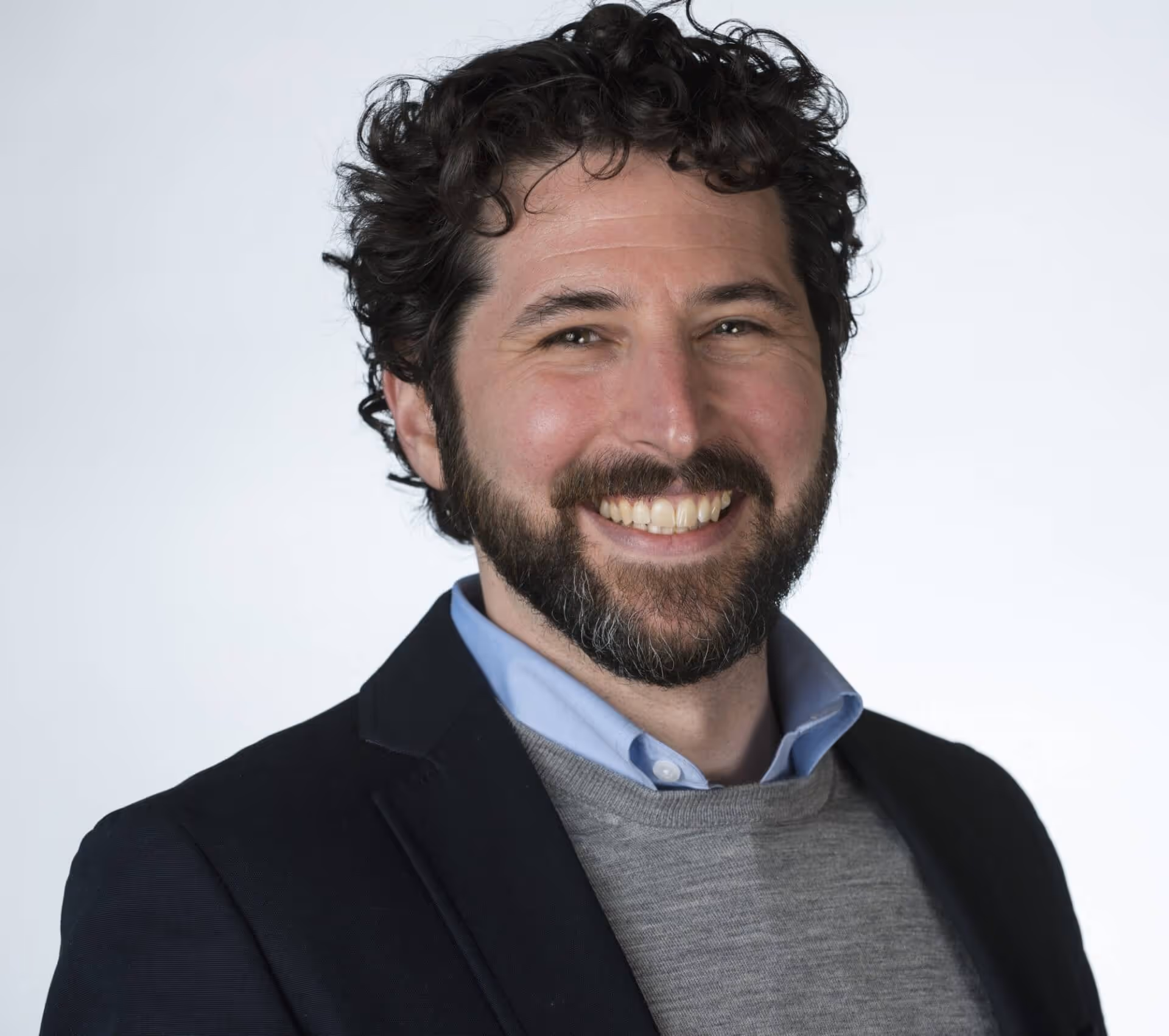 A man in a suit smiling