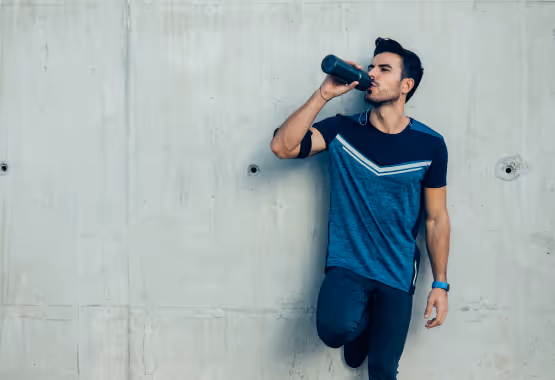 man drinking a hydrating beverage 