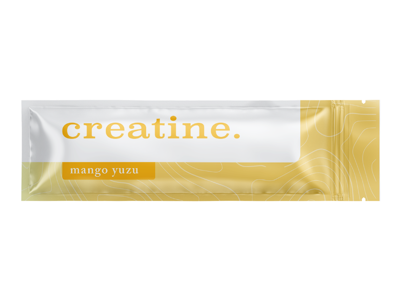 Single-use packet of creatine powder with packaging that is white and gold, labeled 'creatine.' and flavor 'mango yuzu'.