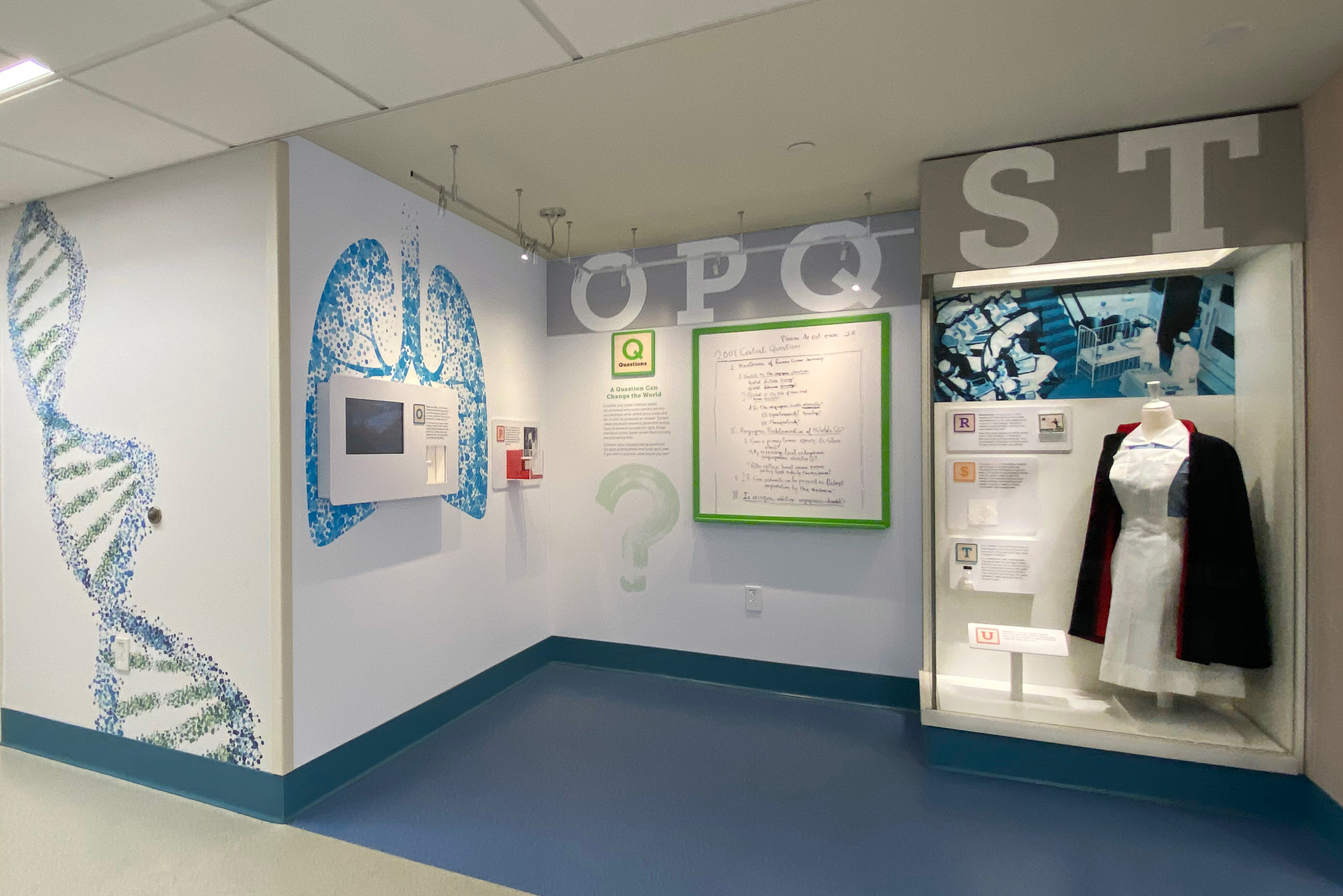 string of letter blocks O to T with artifact case and embedded video screen