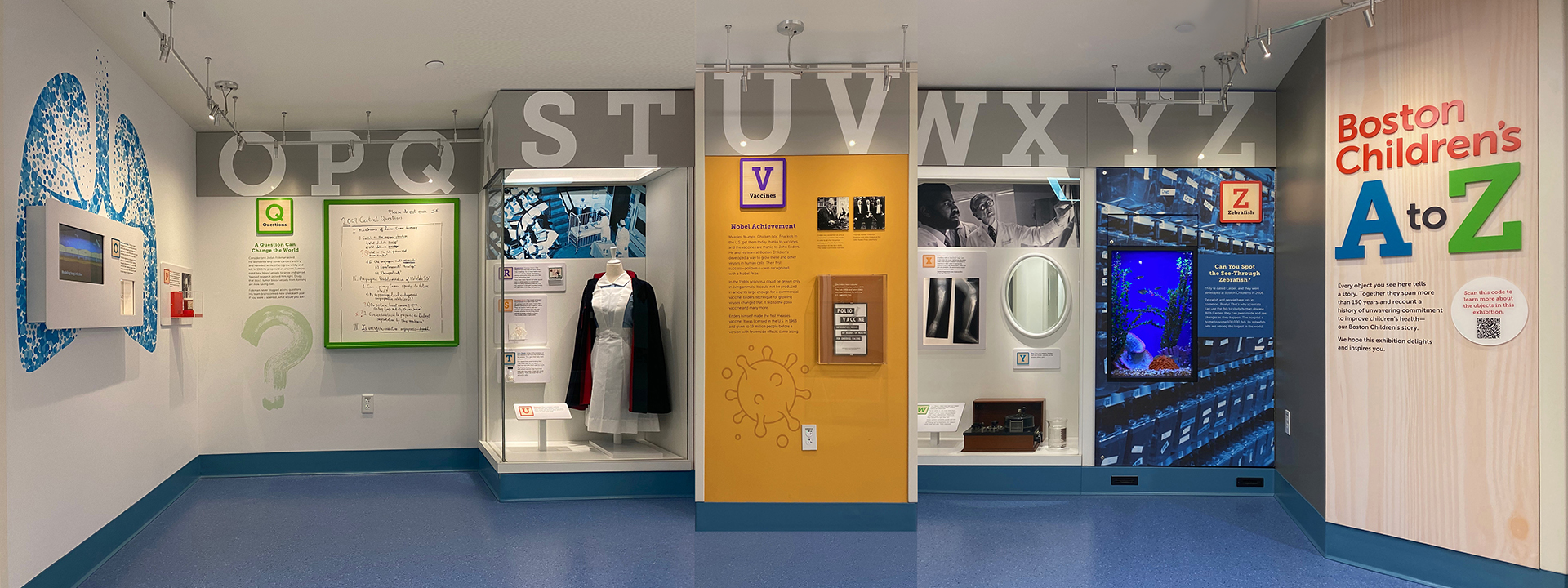 elevation view of hallway exhibit featuring vaccine story in the center and zebrafish tank on the right