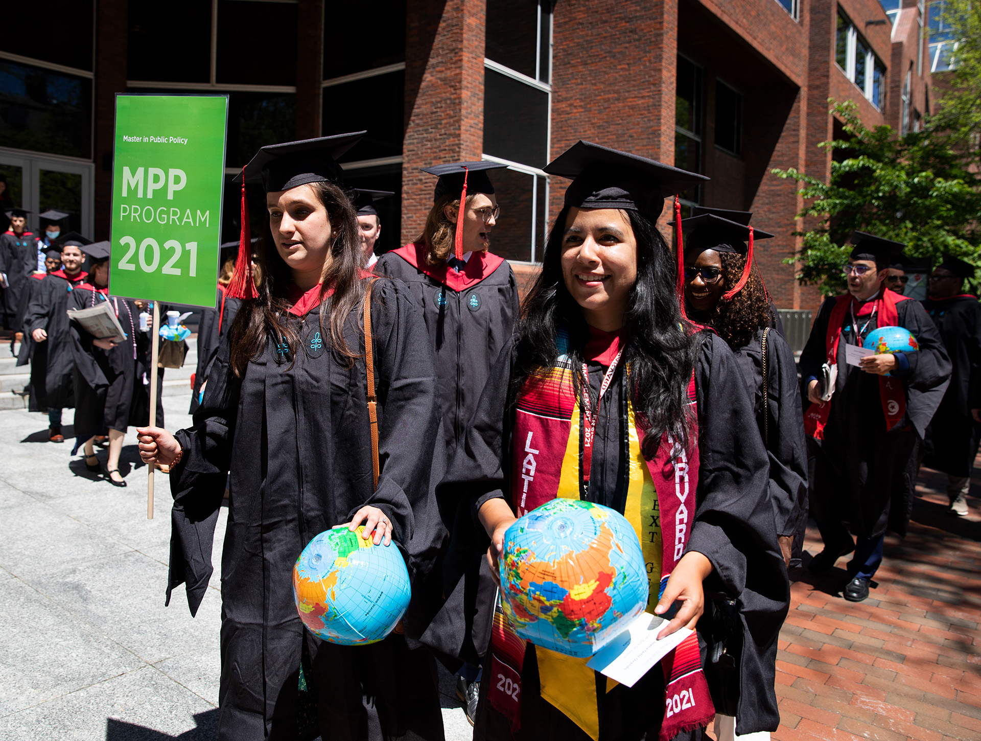 Student carrying MPP sign during Commencement procession