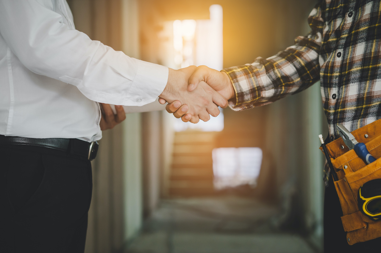 Close up of customer shaking hands with service provider.
