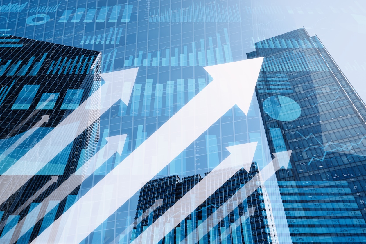 Upward arrows rising over bar graphs and city buildings, representing business growth, increased sales, and strong company performance.
