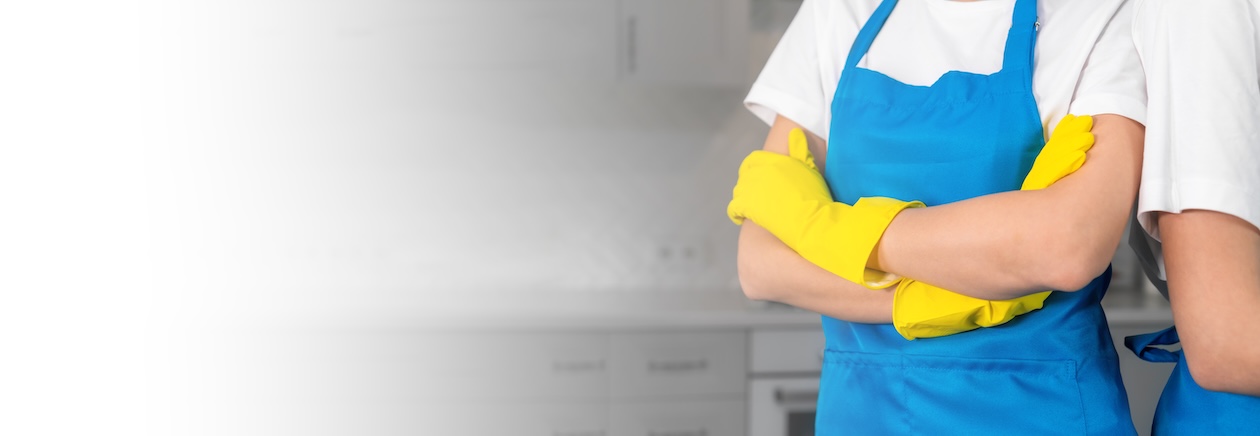 Two cleaning professionals with arms crossed