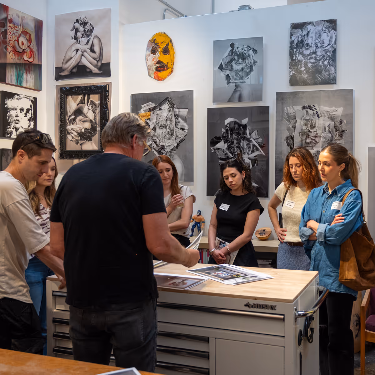 artst in studio showing guests his work