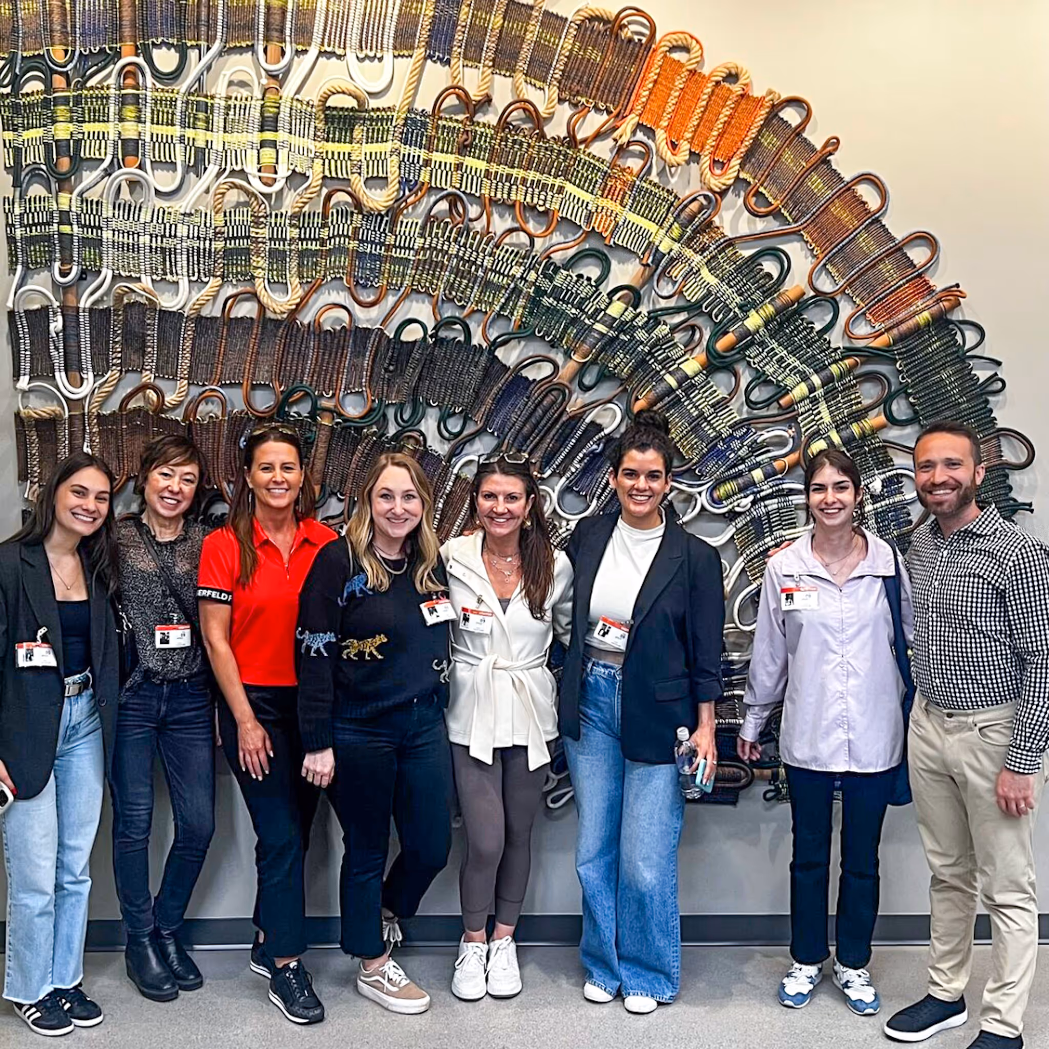 client group picture infront of tapestry