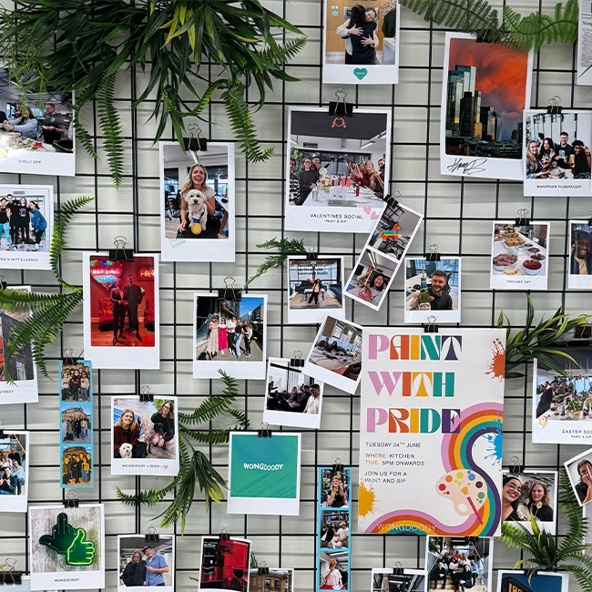 A wall with many different polaroids pinned to it