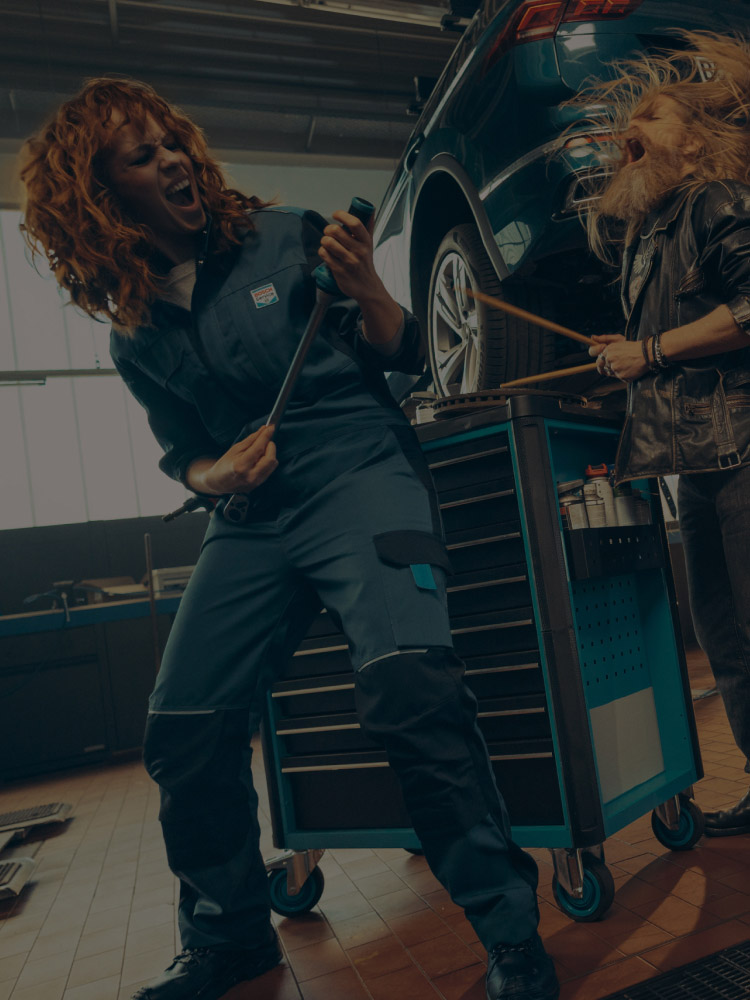 A Bosch Car Service mechanic and customer rocking out together