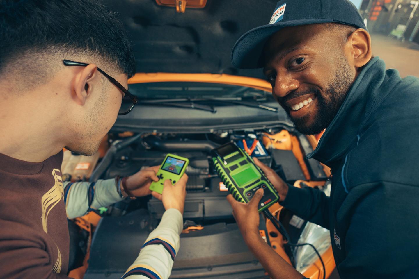 A mechanic and client share their love of handheld devices