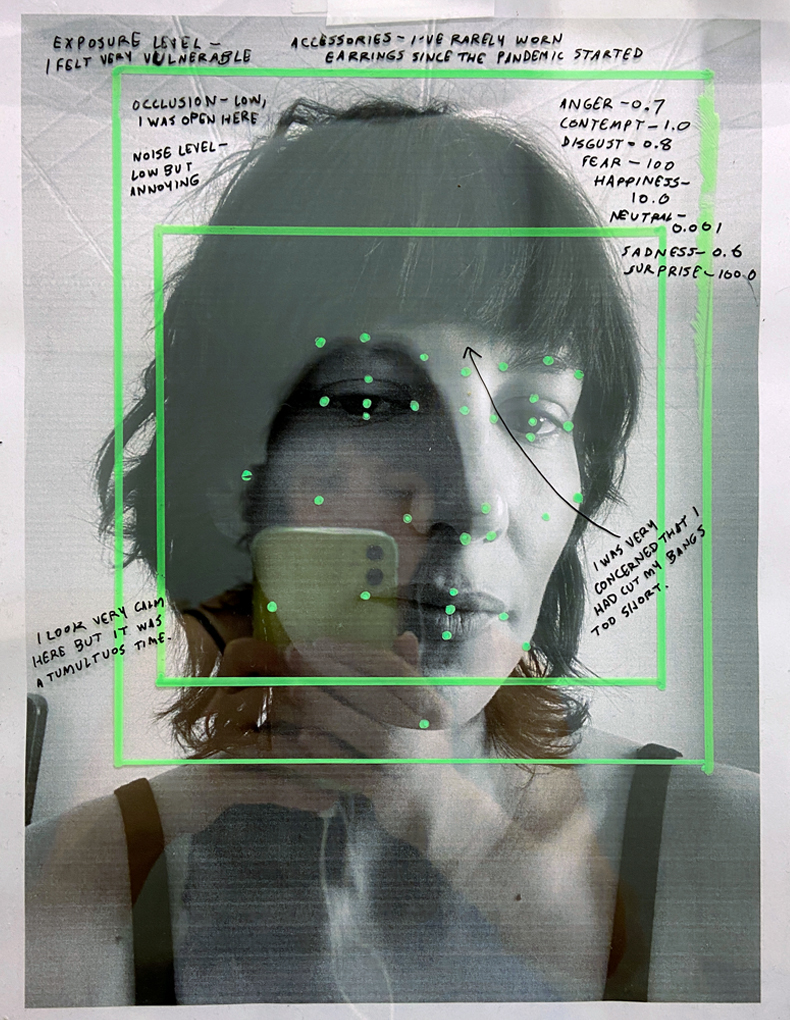 A black-and-white photograph of myself staring into the camera’s lens is covered with hand-drawn lines and dots that evoke the interface for facial recognition software. The photograph is reflective, and you can glimpse my hands holding an iPhone.