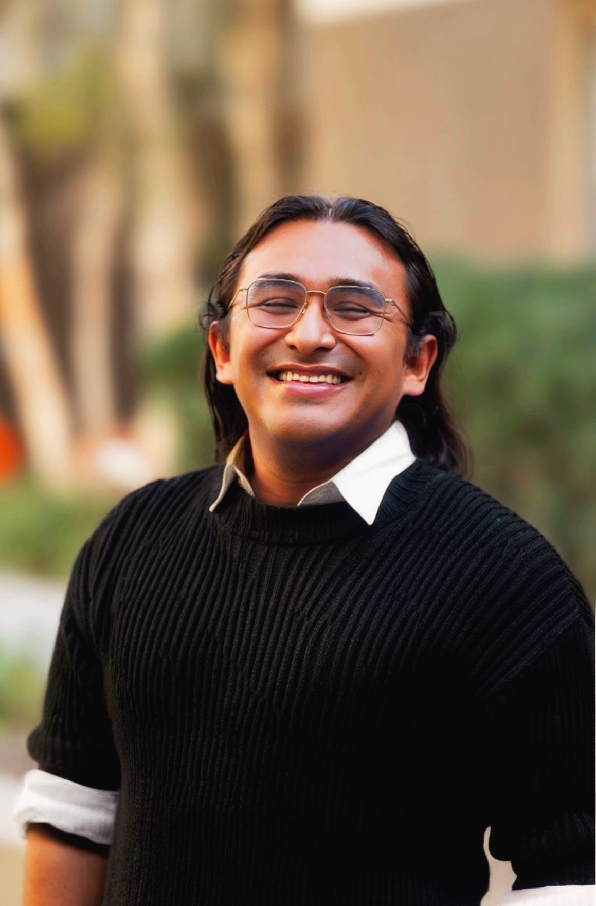 A portrait showing the creator sitting down at a table