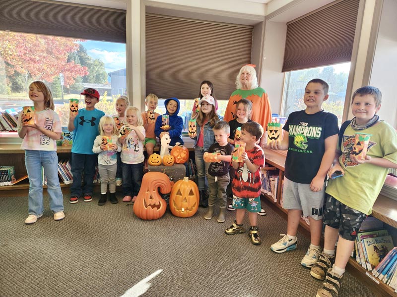 Children at the Meadows Valley Library show off their craft creations.Photo credit: Rachel Reynaga