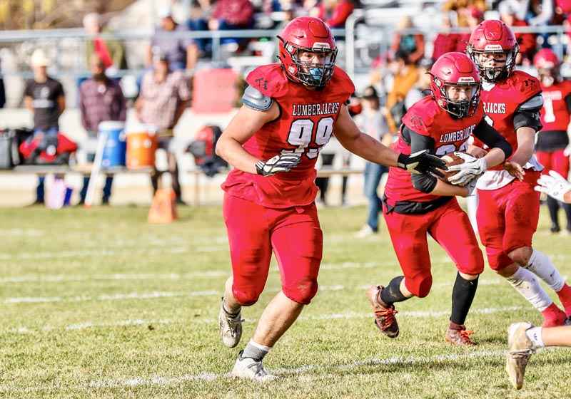 #33 Sophomore Brody Davis runs the ball while #99 Remington Crowell blocks.Photo credit: Patty Guilford, www.gameframephoto.com.
