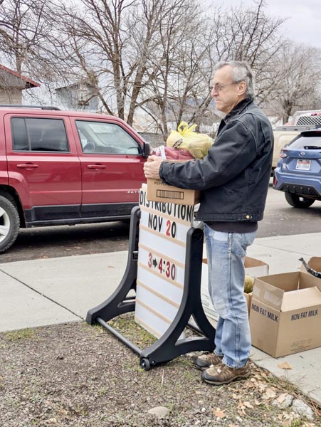 Volunteer Bob Gratton helps with passing out food at the Loaves and Fishes Food Pantry on November 20.