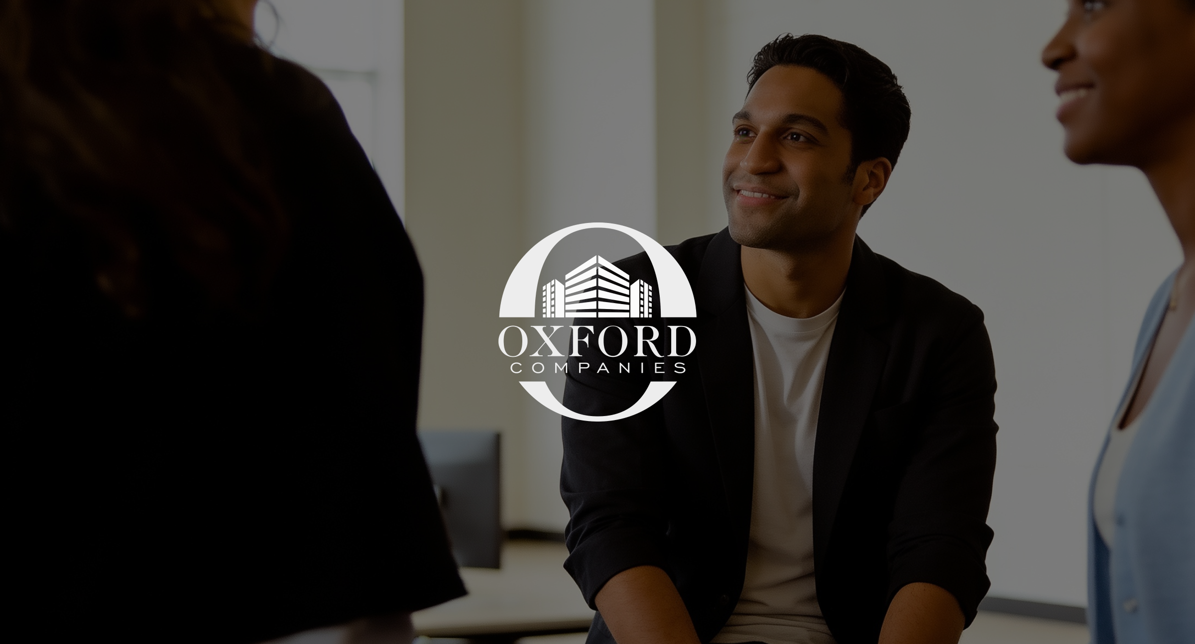 Image of everyday life in the office with a white logo on top of the image