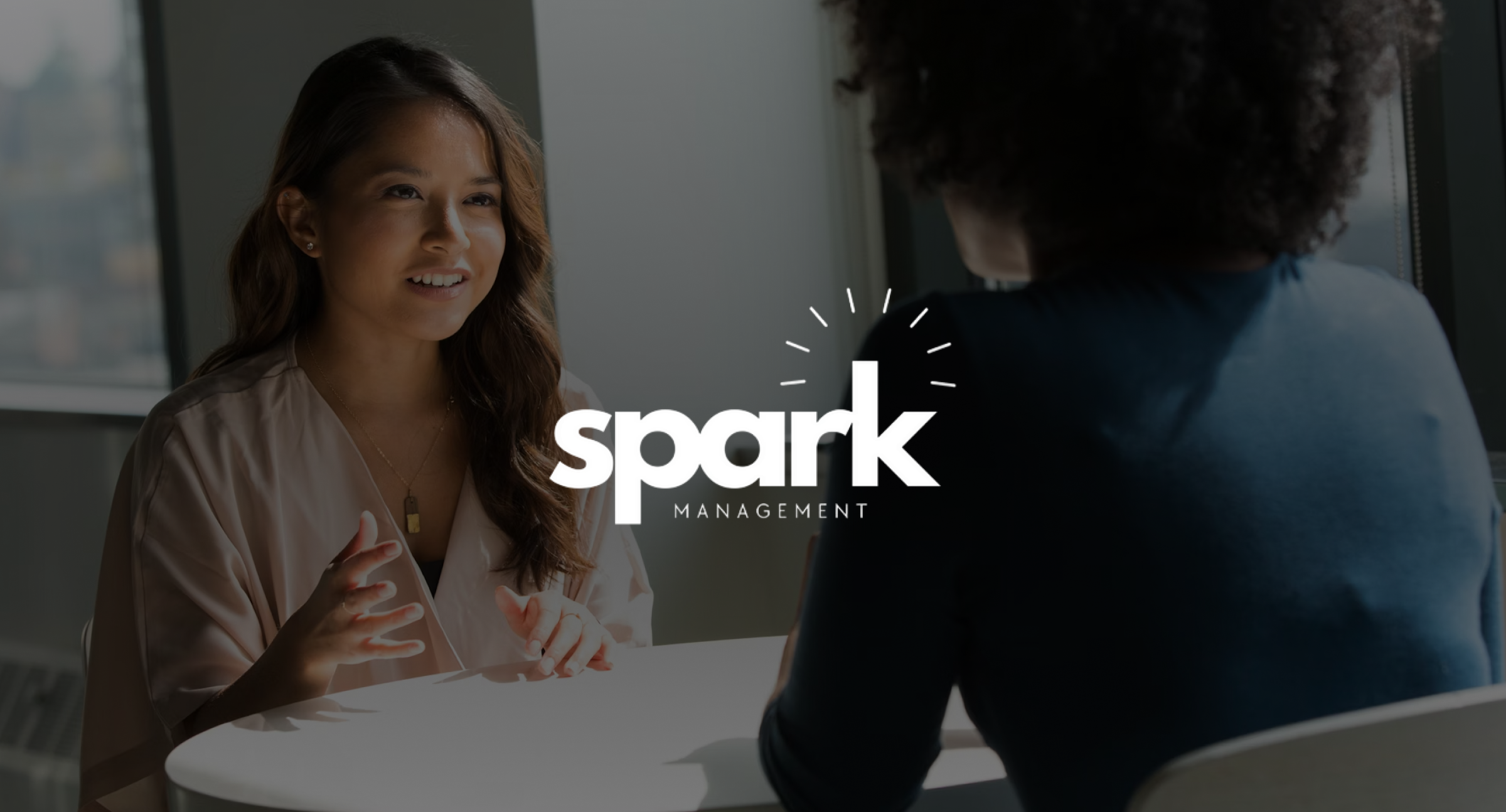 Image of everyday life in the office with a white logo on top of the image