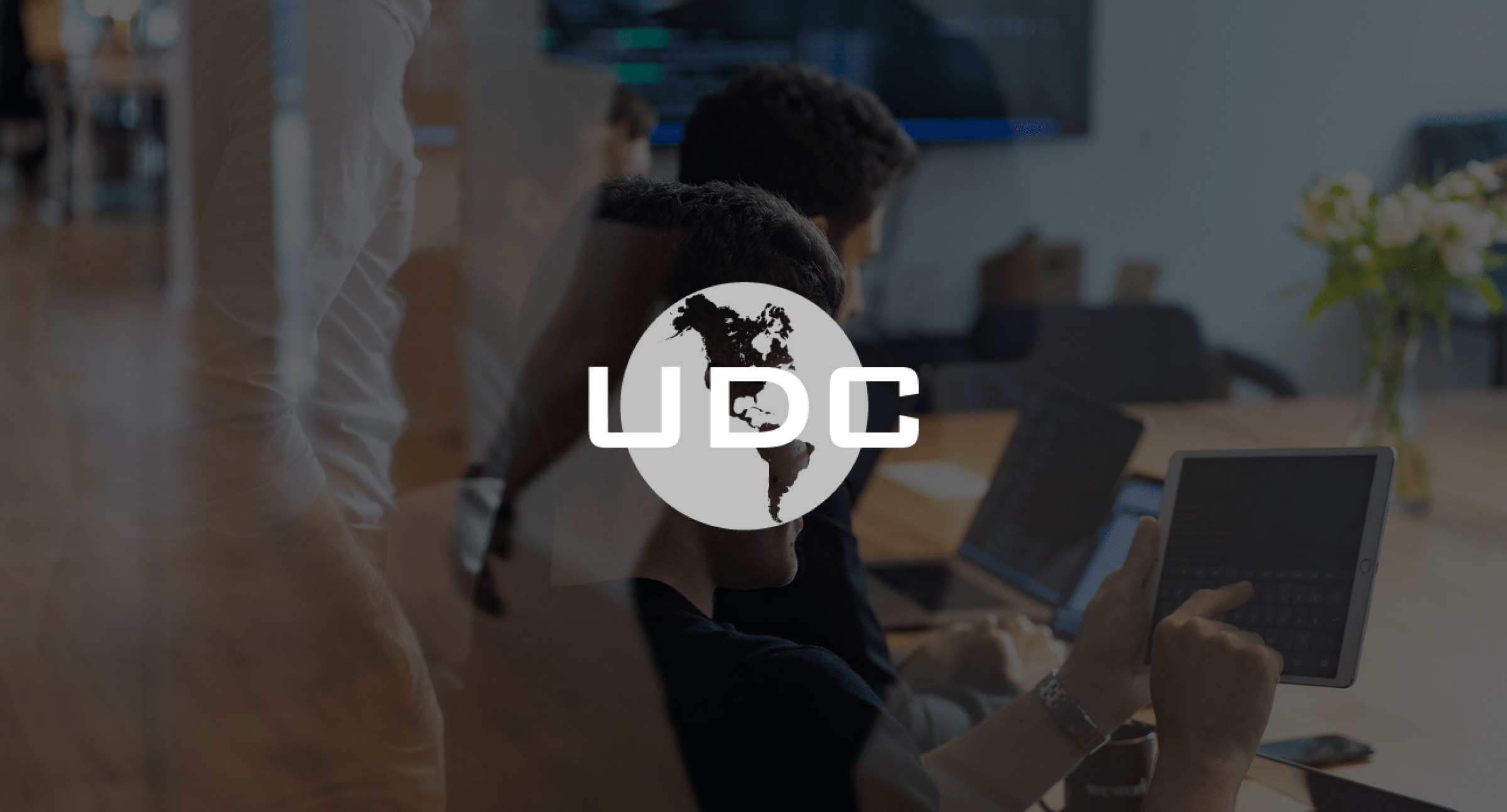 Image of everyday life in the office with a white logo on top of the image