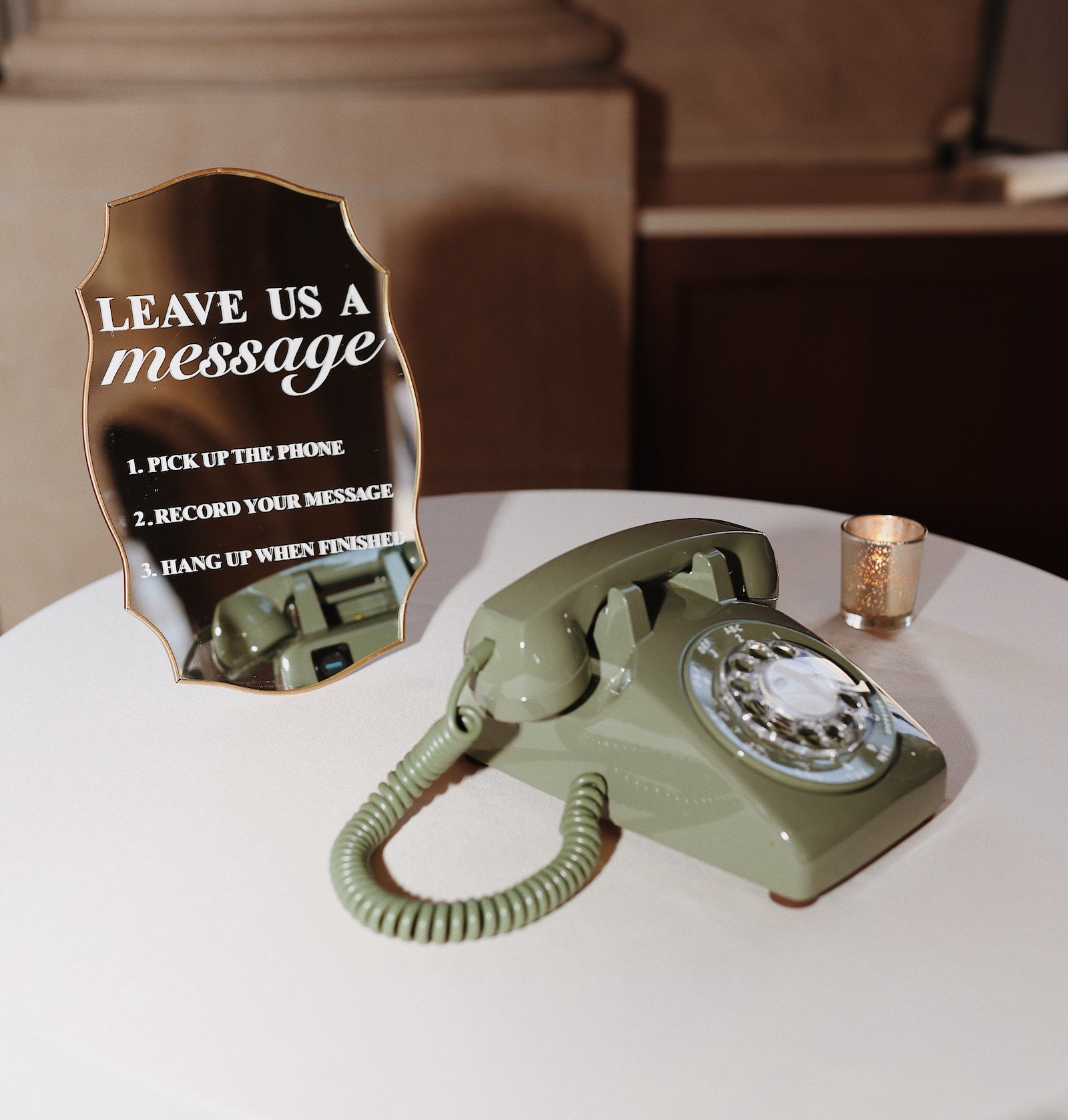 A green rotary phone guest book on the wedding guestbook table.
