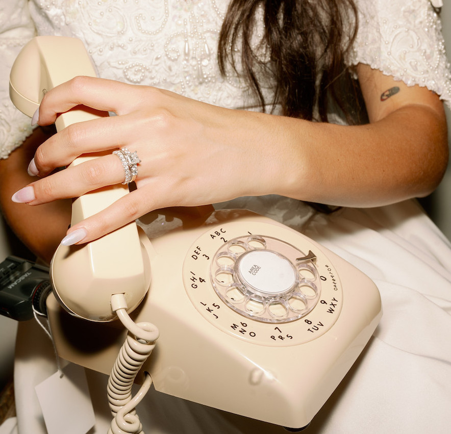 Bride leaves a voicemail on a beige audio guestbook.