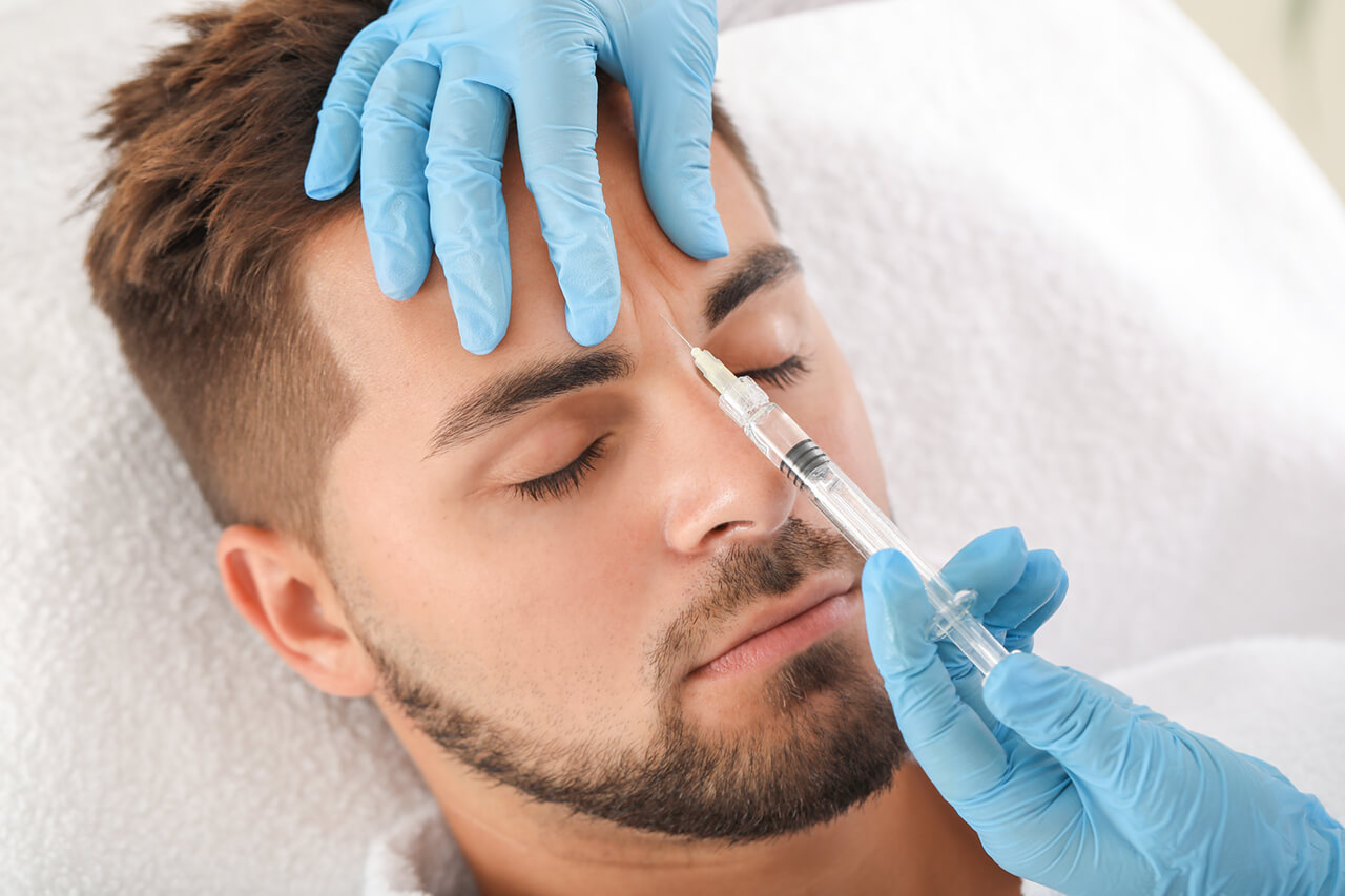 Nurse injecting between the brows to relax frown lines