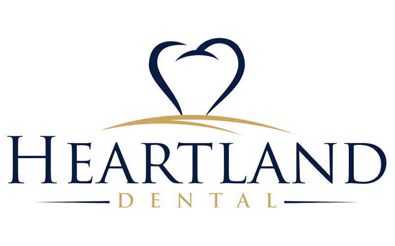 Heartland Dental logo featuring text with a stylized heart and smile graphic above.