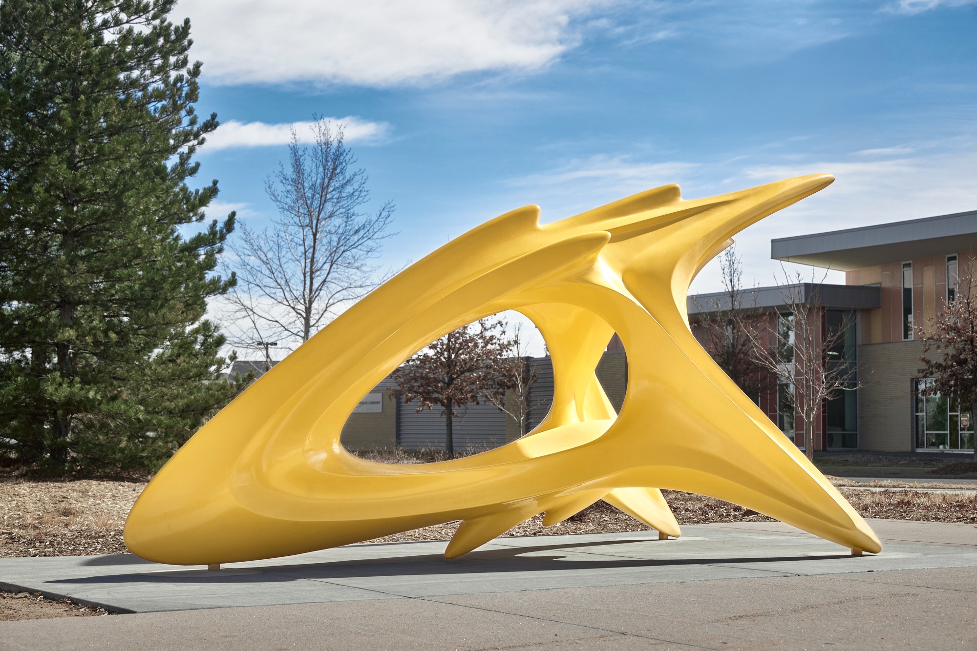 Orbit by Volkan Alkanoglu, a large yellow public sculpture installed in Denver