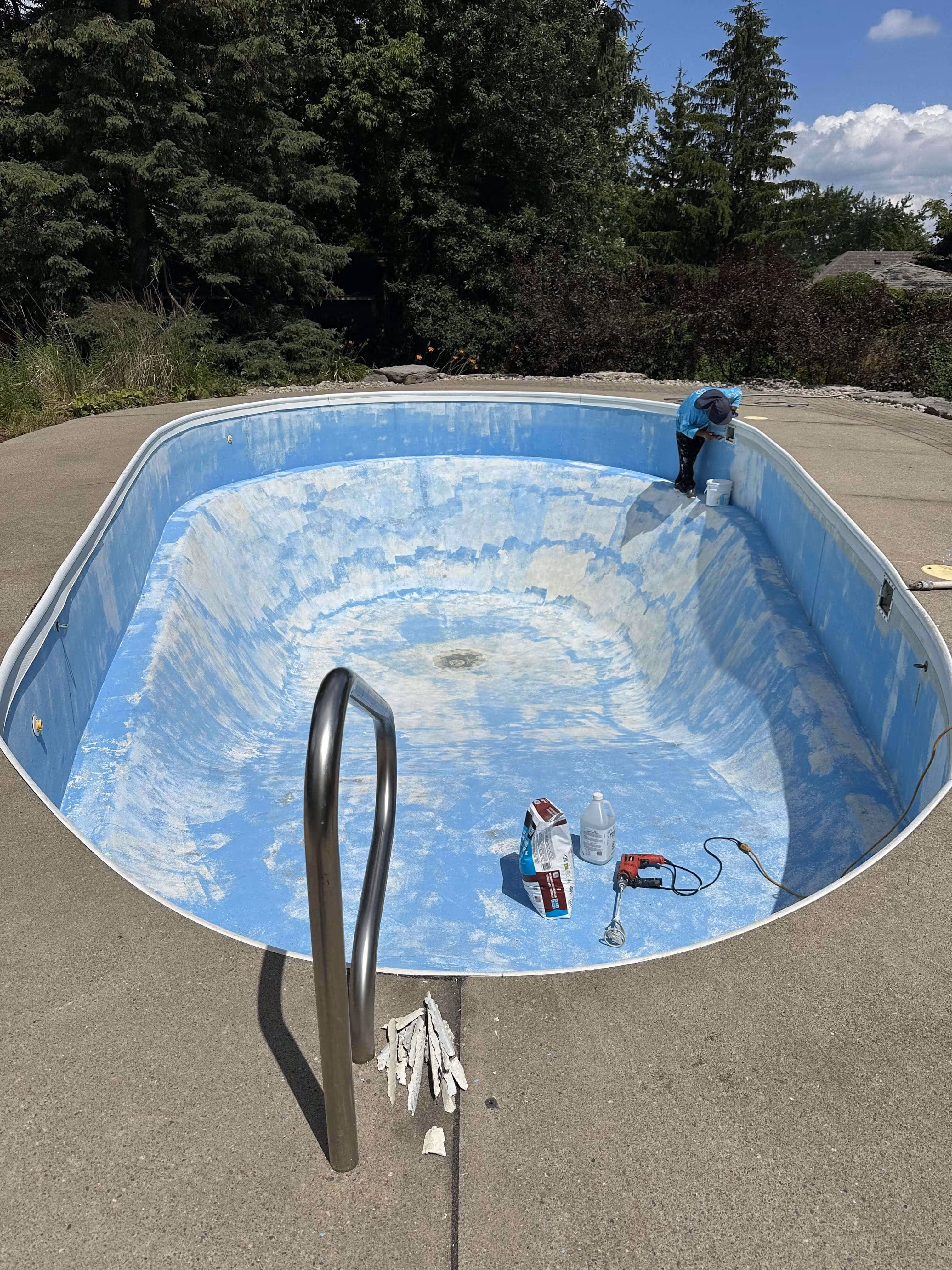 Winter mesh pool cover with water and debris on top of it
