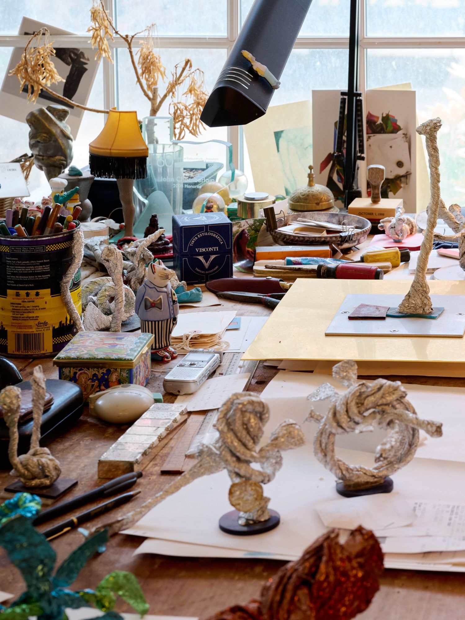 John Chamberlain's Shelter Island studio worktable with foil studies, tools and personal objects.
